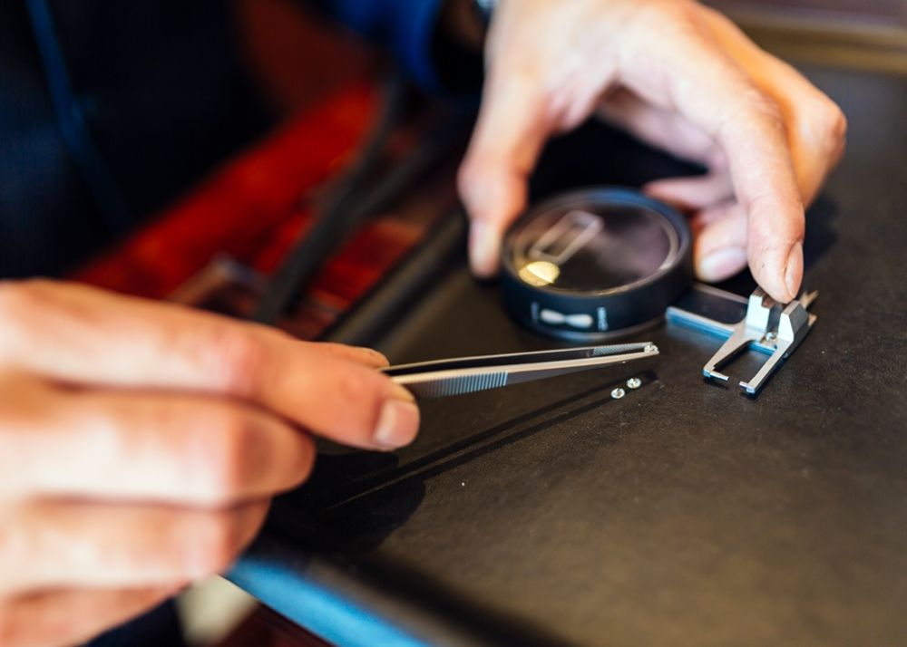 Jeweler checking size of diamond.